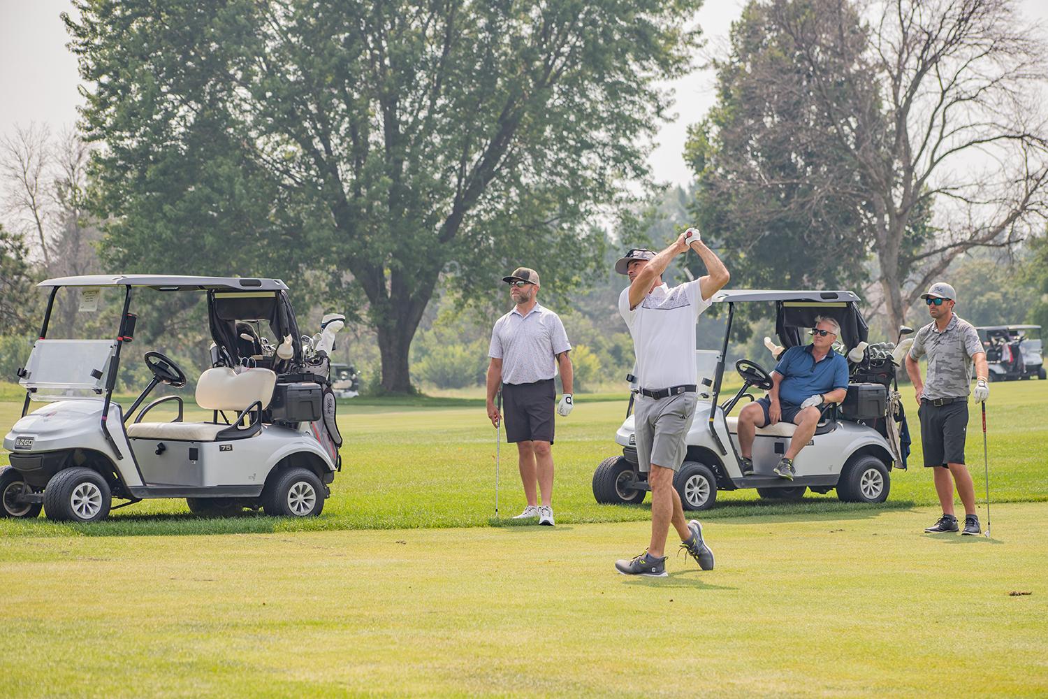 photo of a foursome team member teeing off
